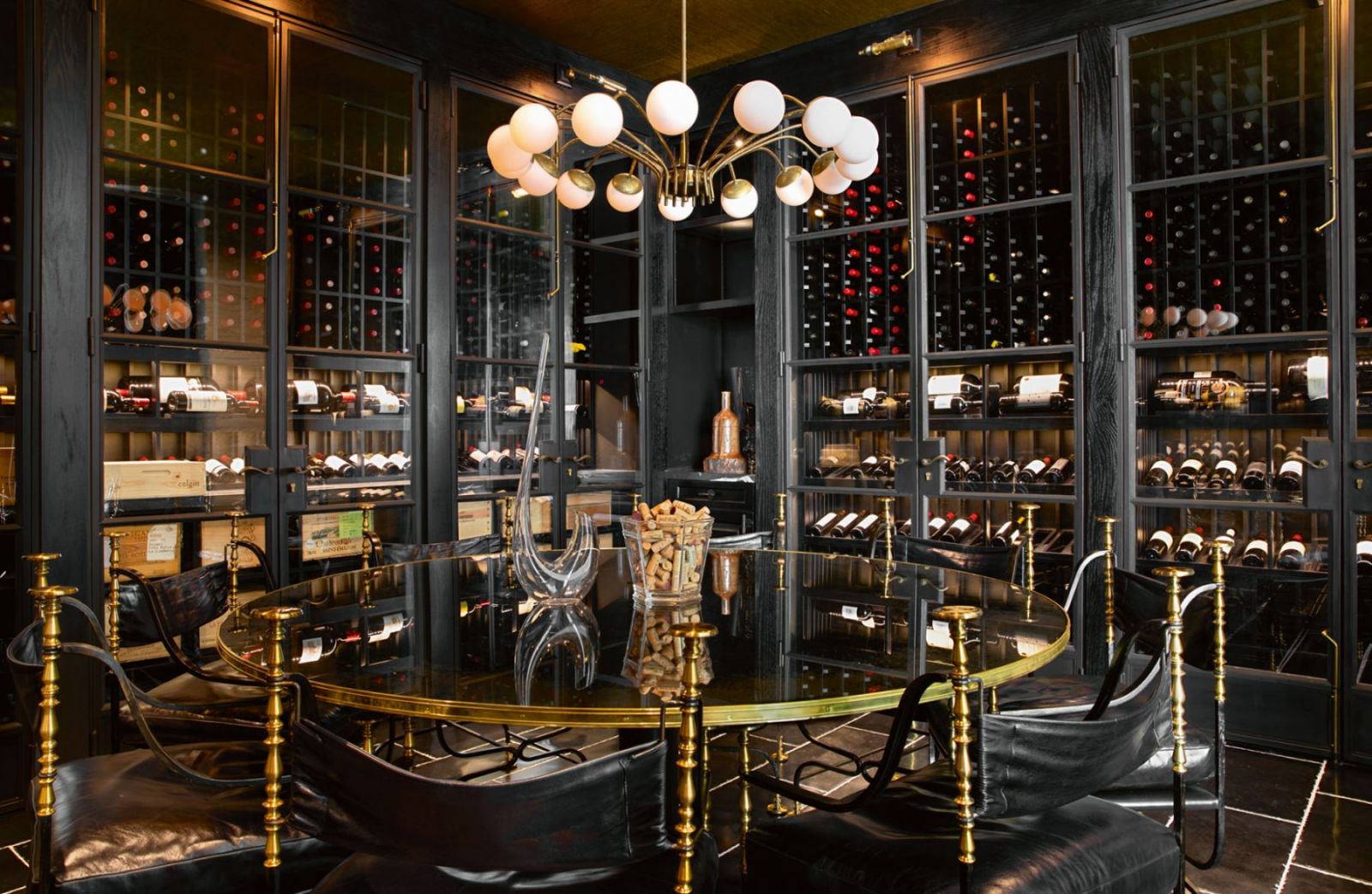 The polished wine room and cellar with brass accents (Photo: Karyn Millet)