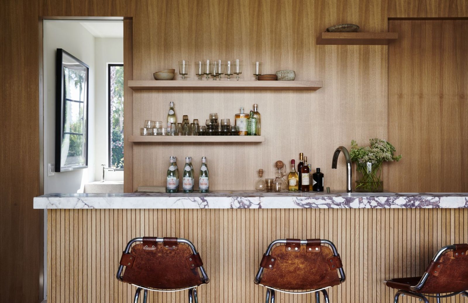 The wood-panelled bar in the pool house (Photo: Amy Neunsinger)