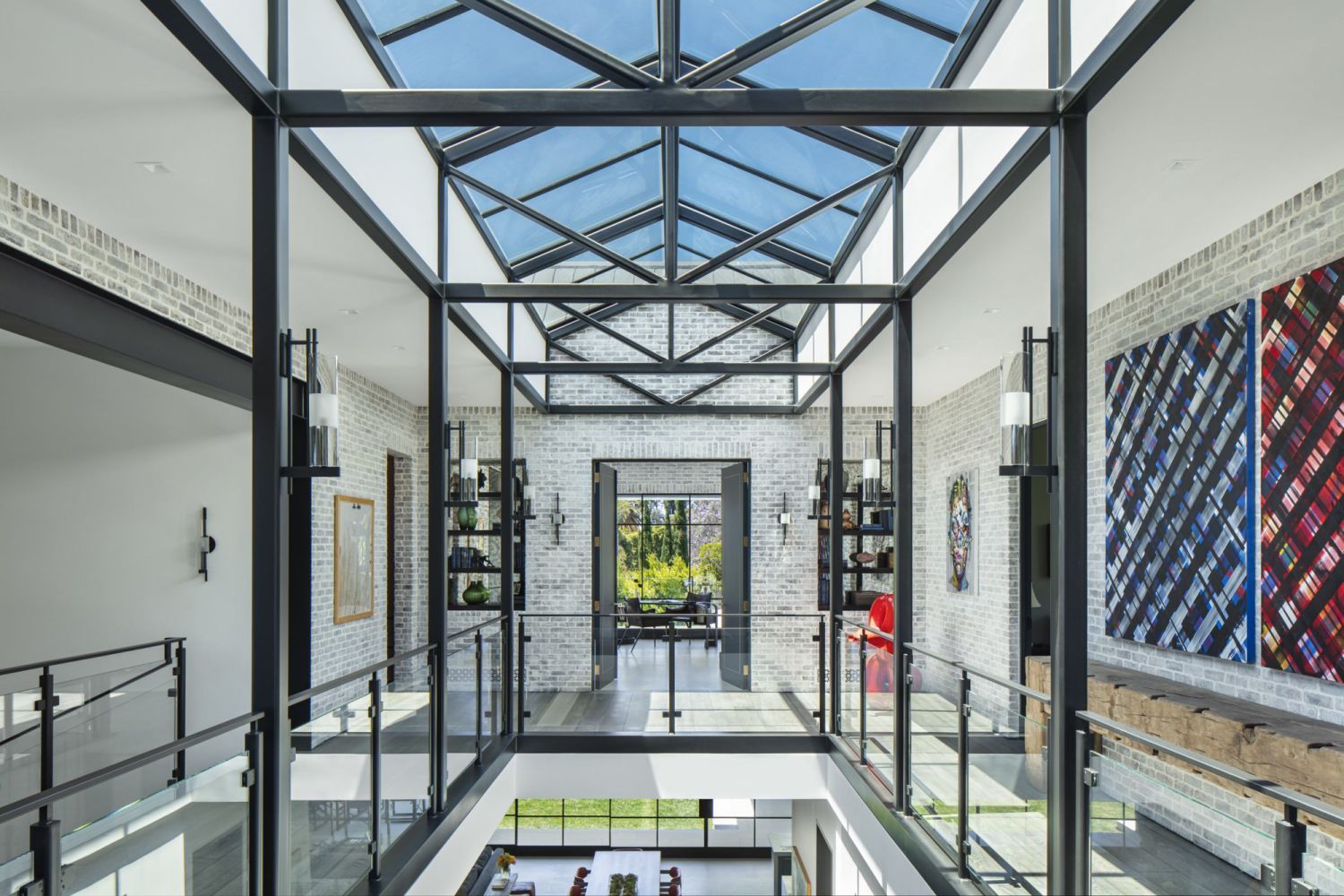 The two-storey central atrium with a vaulted skylight and black steel beams (Photo: Manolo Langis)