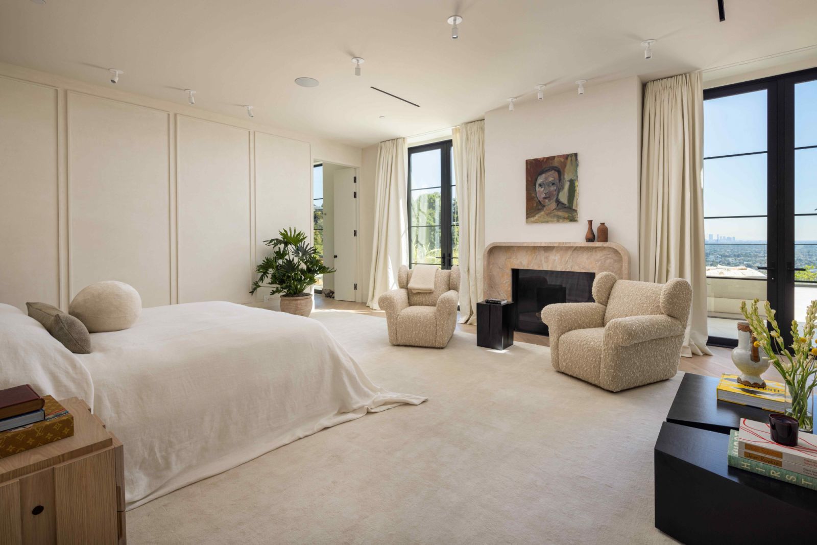 The primary bedroom with a Calacatta Breccia fireplace (Photo: Sam Frost)