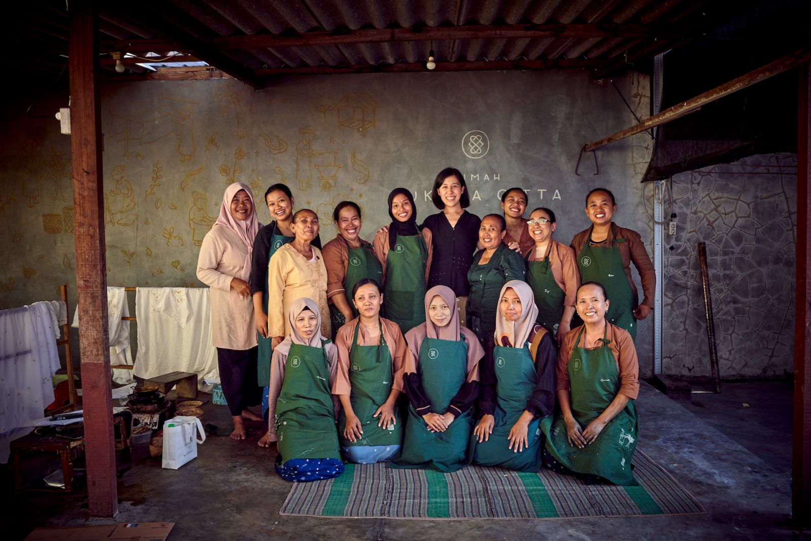 Denica Riadini-Flesch with the batik craftswomen at one of SukkhaCittaâs craft schools Rumah SukkhaCitta. Women are not only taught traditional crafts in SukkhaCitta schools, but the business skills they need to monetize them.