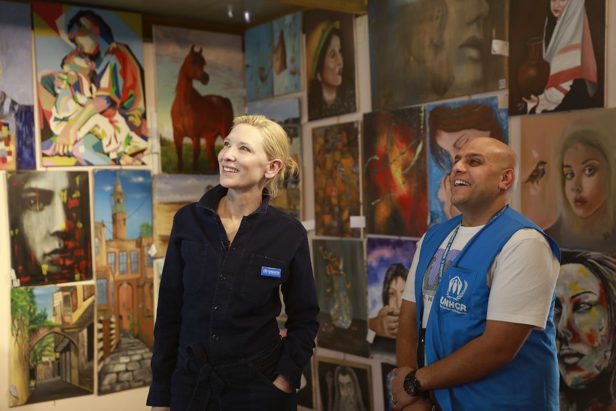 UNHCR Goodwill Ambassador Cate Blanchett views art painted by refugees in the Art Gallery in the community centre in District 2 of Zaatari refugee camp with UNHCR staff member Omar Al-Muheisen. Image: UNHCR/Caroline Irby