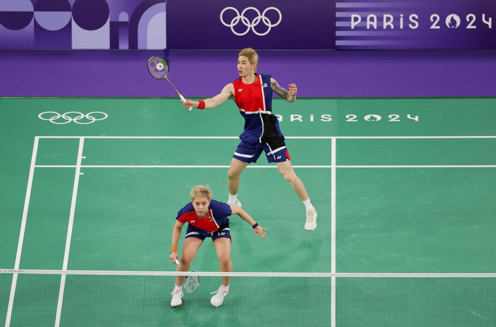 PARIS, FRANCE - JULY 29: Tang Jie Chen and Ee Wei Toh of Team Malaysia compete during the Mixed Doubles Group Play Stage - Group D match between Team People’s Republic of China and Team Malaysia on day three of the Olympic Games Paris 2024 at Porte de La Chapelle Arena on July 29, 2024 in Paris, France. (Photo by Ezra Shaw/Getty Images)