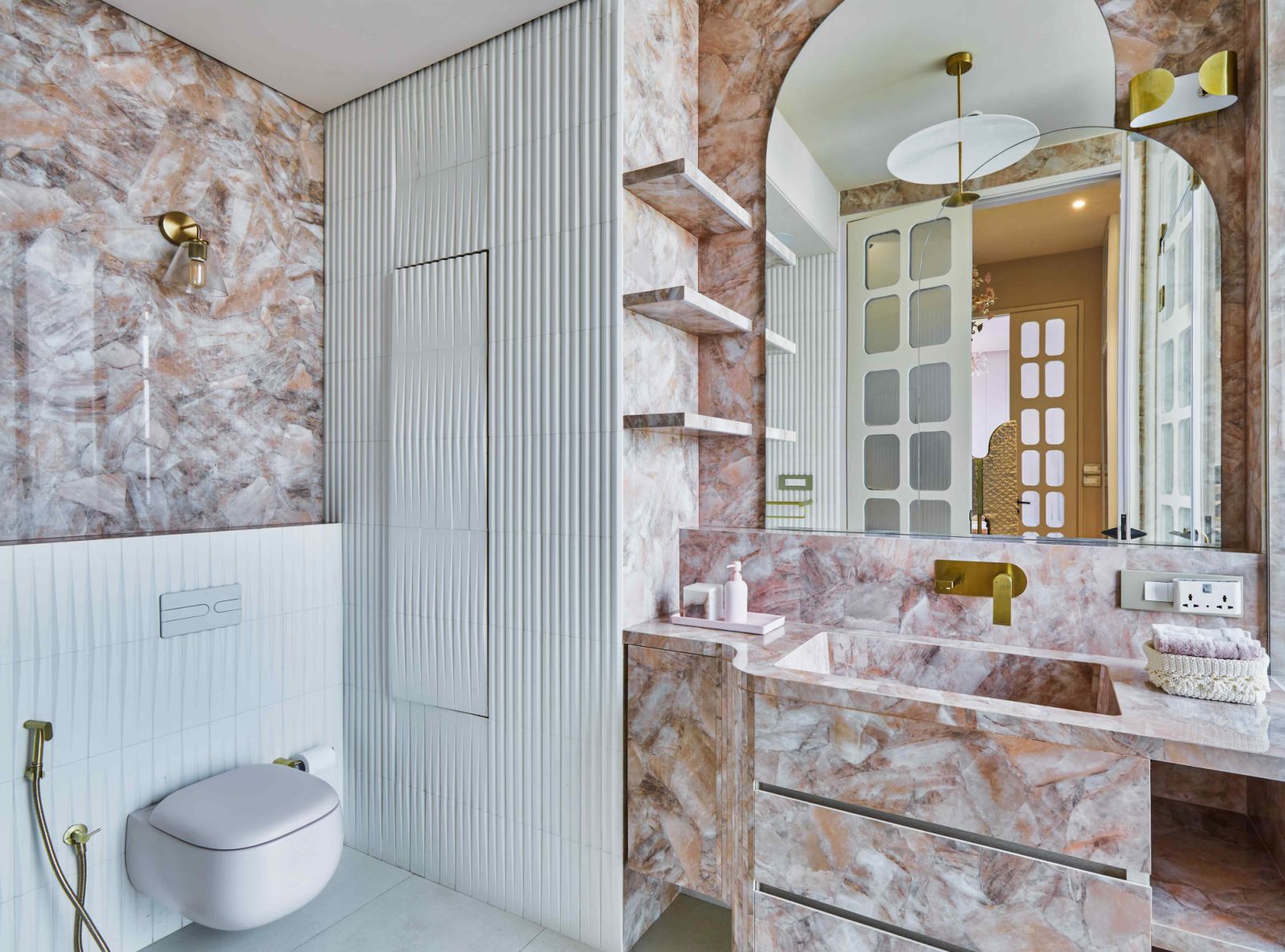 The primary ensuite with rose quartz and fluted tile wall