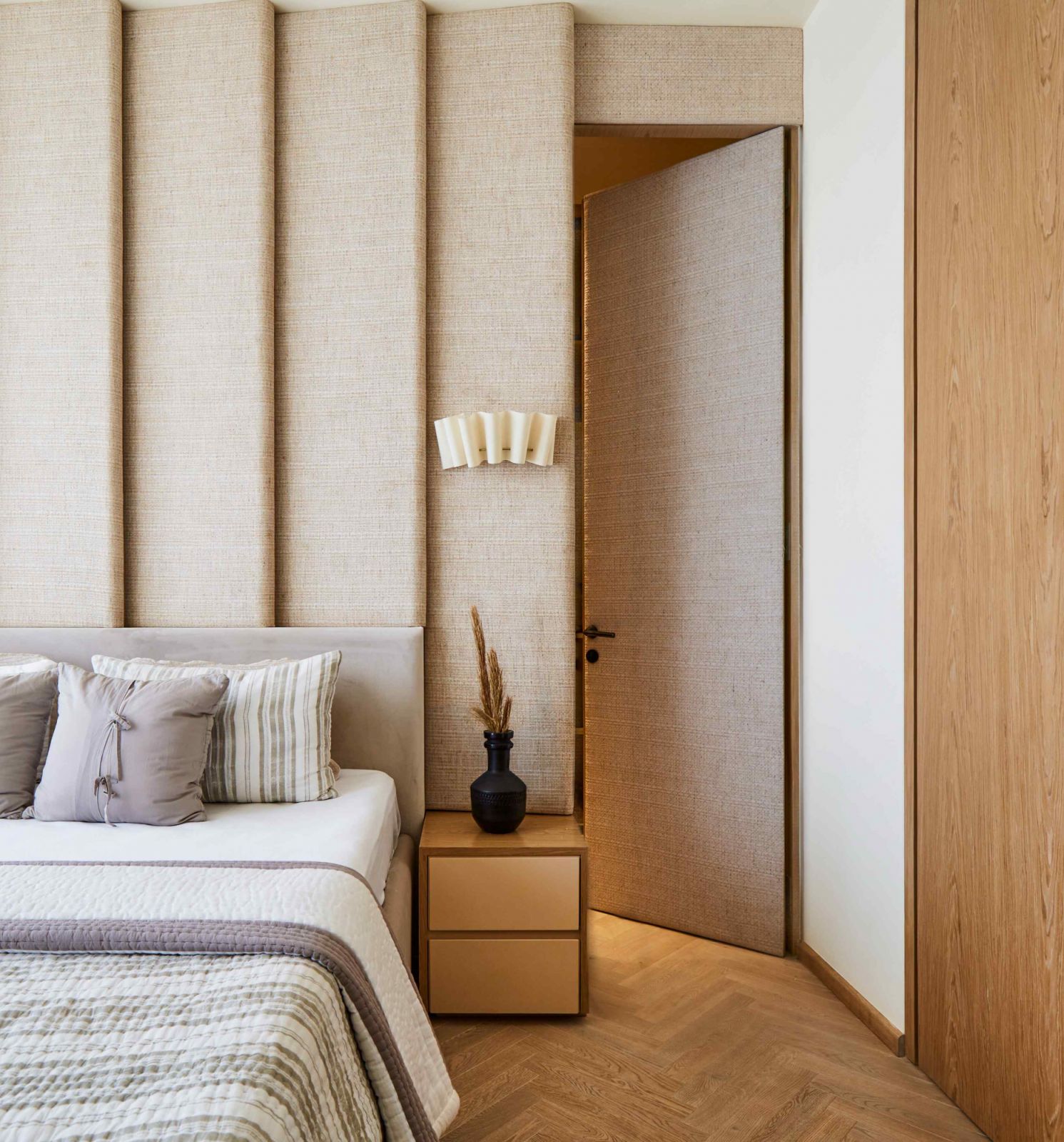 The muted wall panels in the bedroom downstairs lead into a walk-in wardrobe