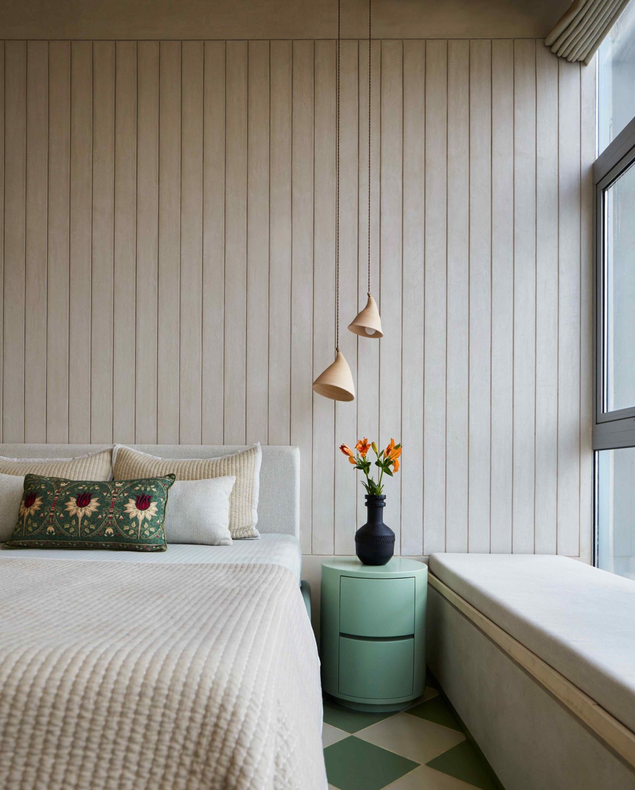 The guest bedroom with a sage and white checkerboard flooring